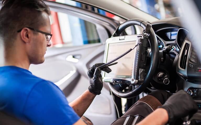 Engineer working on the inside of a car