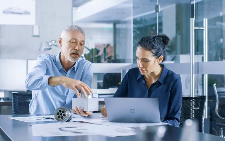 Two engineers working together as a drafting table