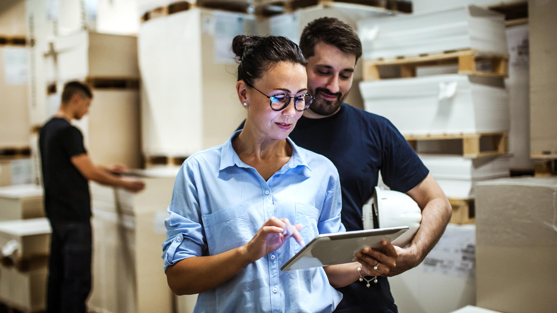 Female project manager going over priorities with male worker.