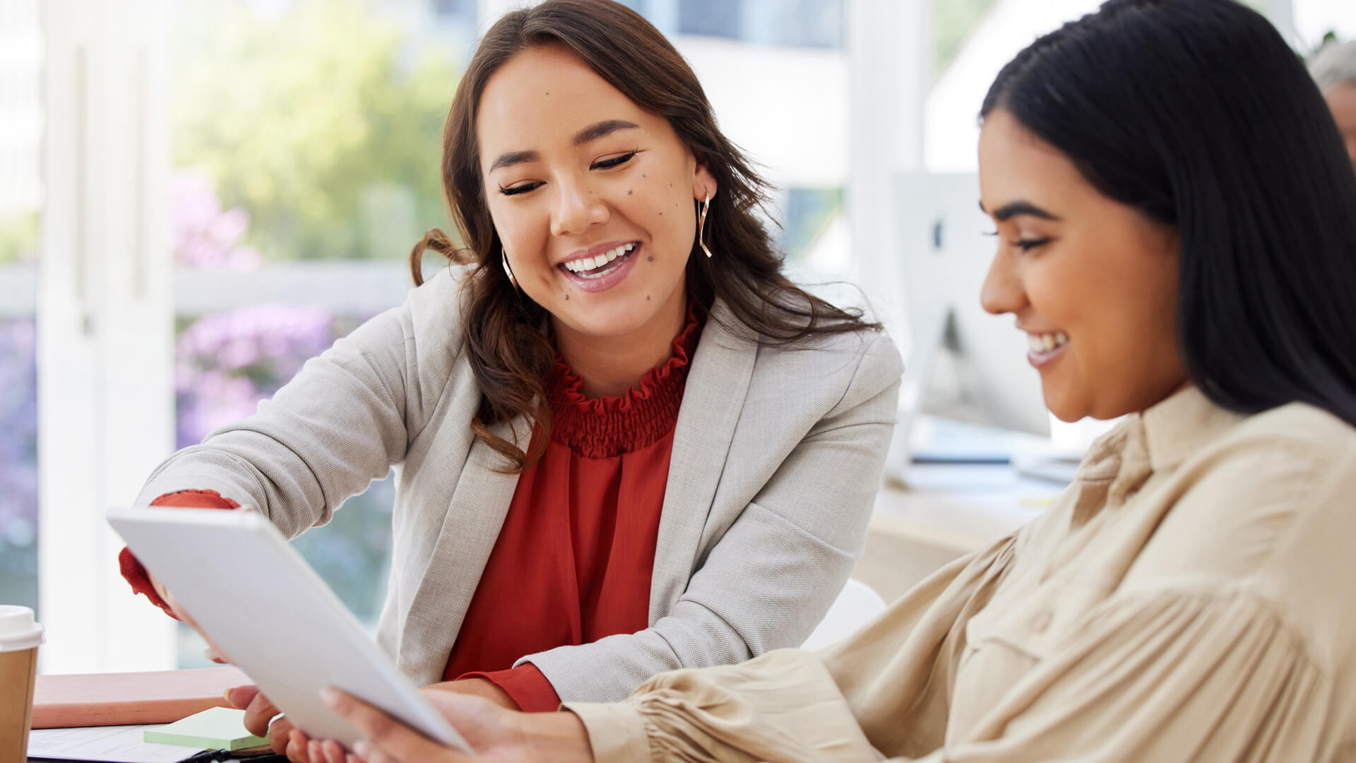 Female coworkers reviewing the January 2025 jobs report looking at the December 2024 labor market and economy data.